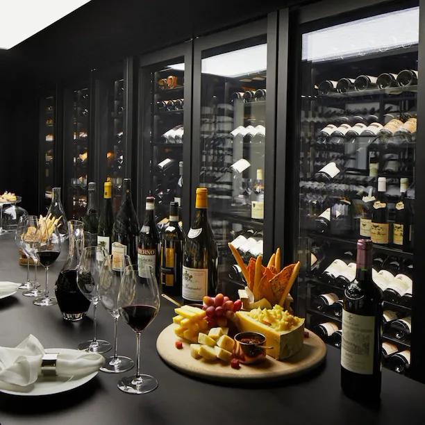 Wine vault with table set with red wine and cheese board