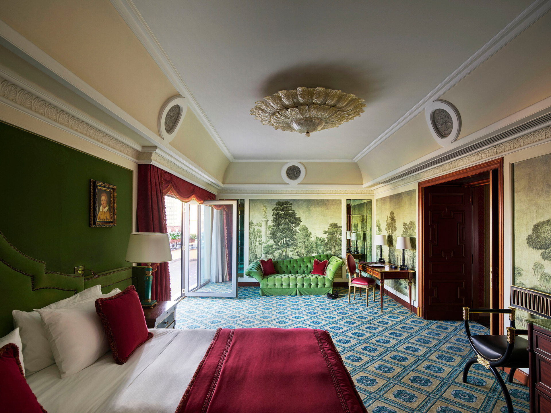 A large view of the second bedroom in the Presidential Suite with a focus on the wall hand-made painting and the terrace  detail 