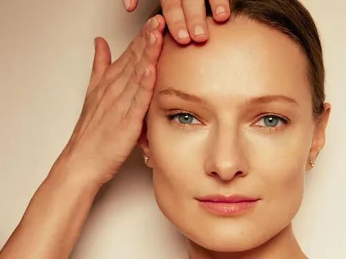 Model receiving treatment for spa masterclass demonstration for Natura Bissé in warm lighting