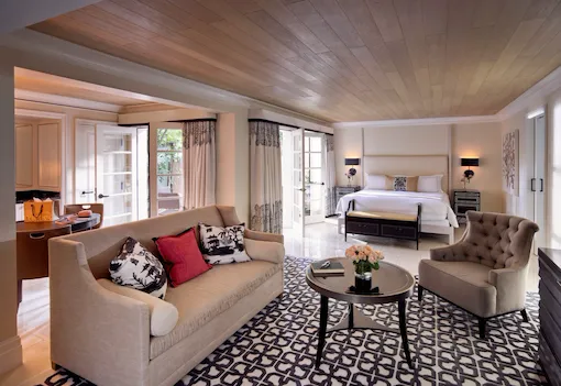 Sitting area and king sized bed Junior Pool Suite