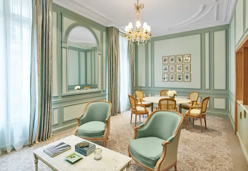 Living room of a superior suite in green tones at Le Meurice, Paris.