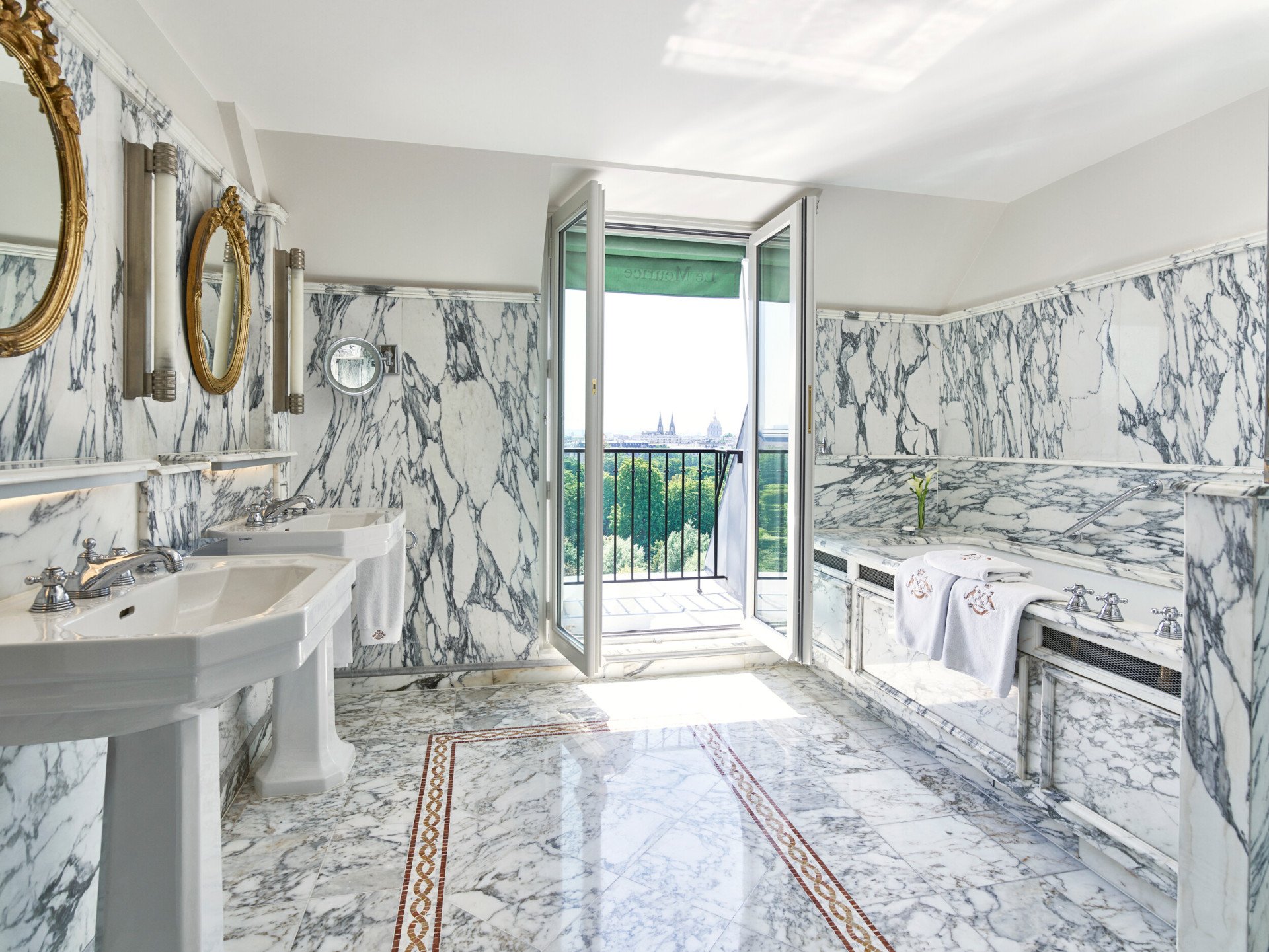 Marble bathroom with bathtub overlooking the Tuileries gardens in an executive room. At Le Meurice, Paris.