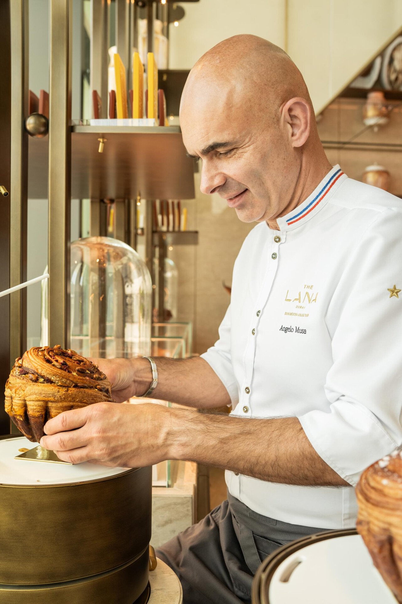 Images depicting pastries, team and interior details at Bonbon Café Angelo Musa located at The Lana, Dorchester Collection, Dubai. 