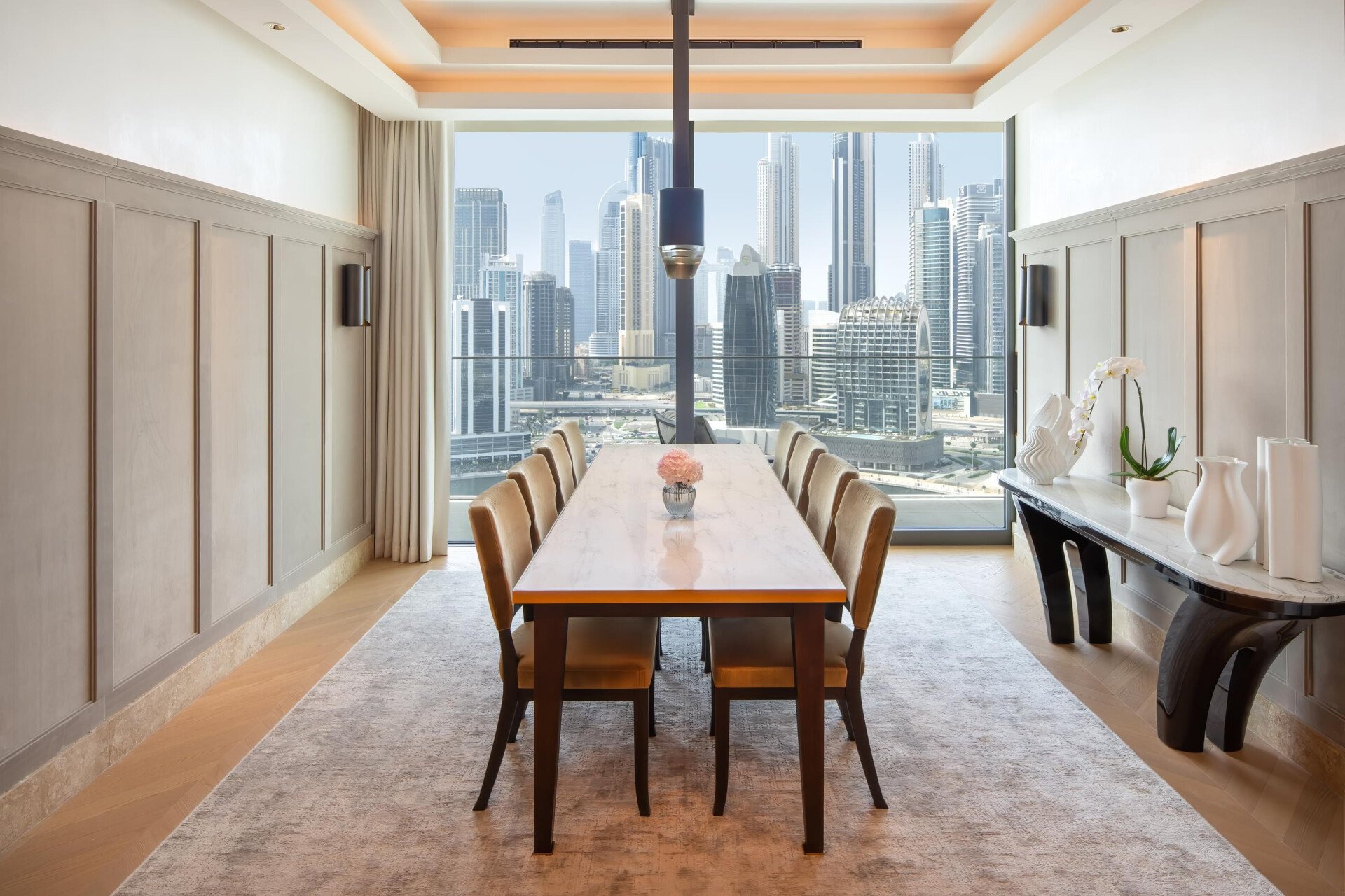 Image of The Lana Royal Suite dining area, including skyline view of Dubai during daytime.