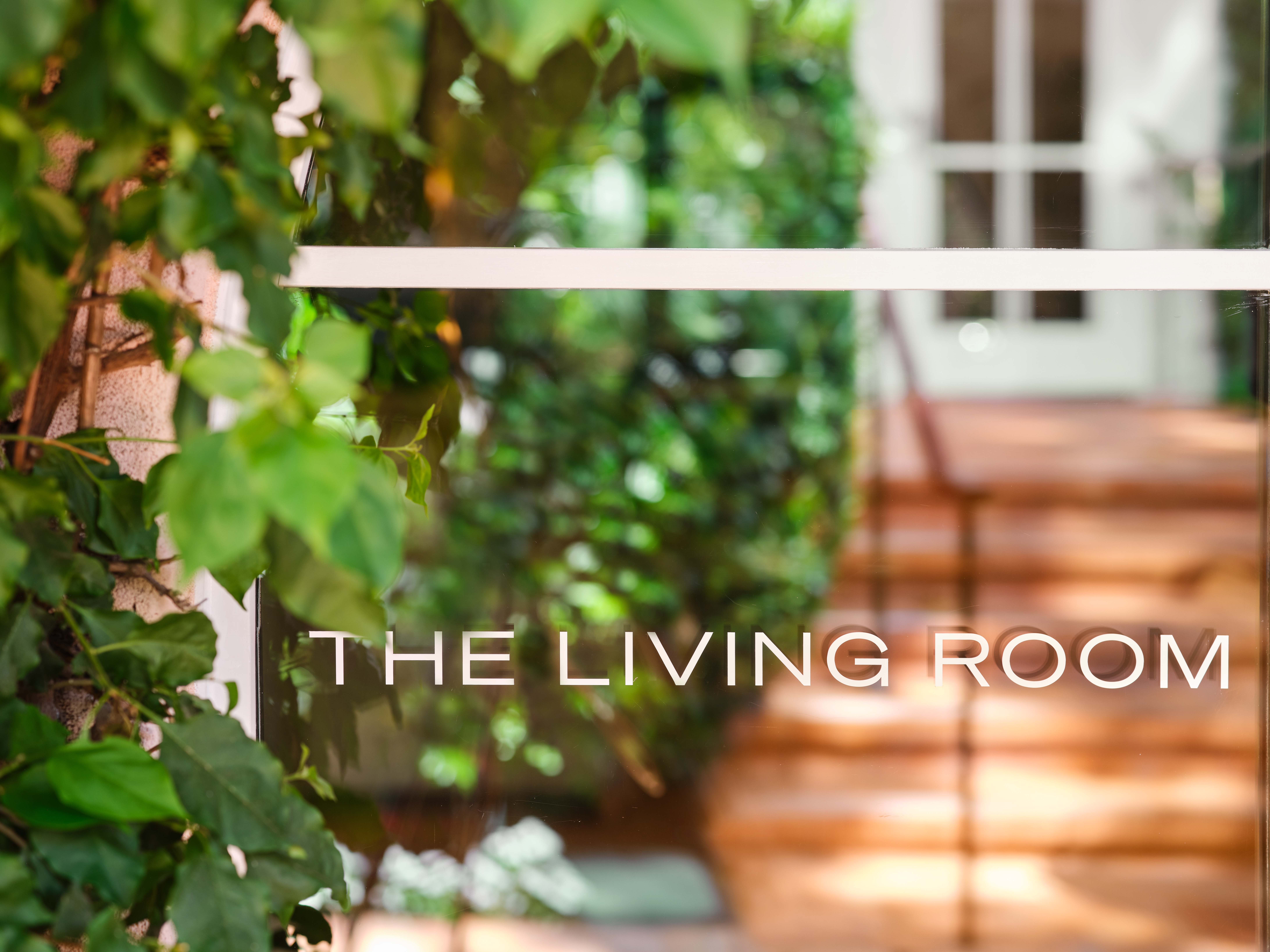 The Living Room white signage on window pane