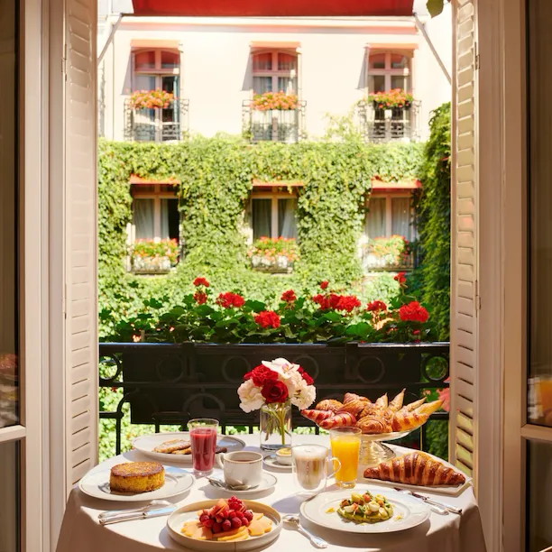 Images of the brunch in room showing pastries and fresh fruits with a view on La Cour Jardin