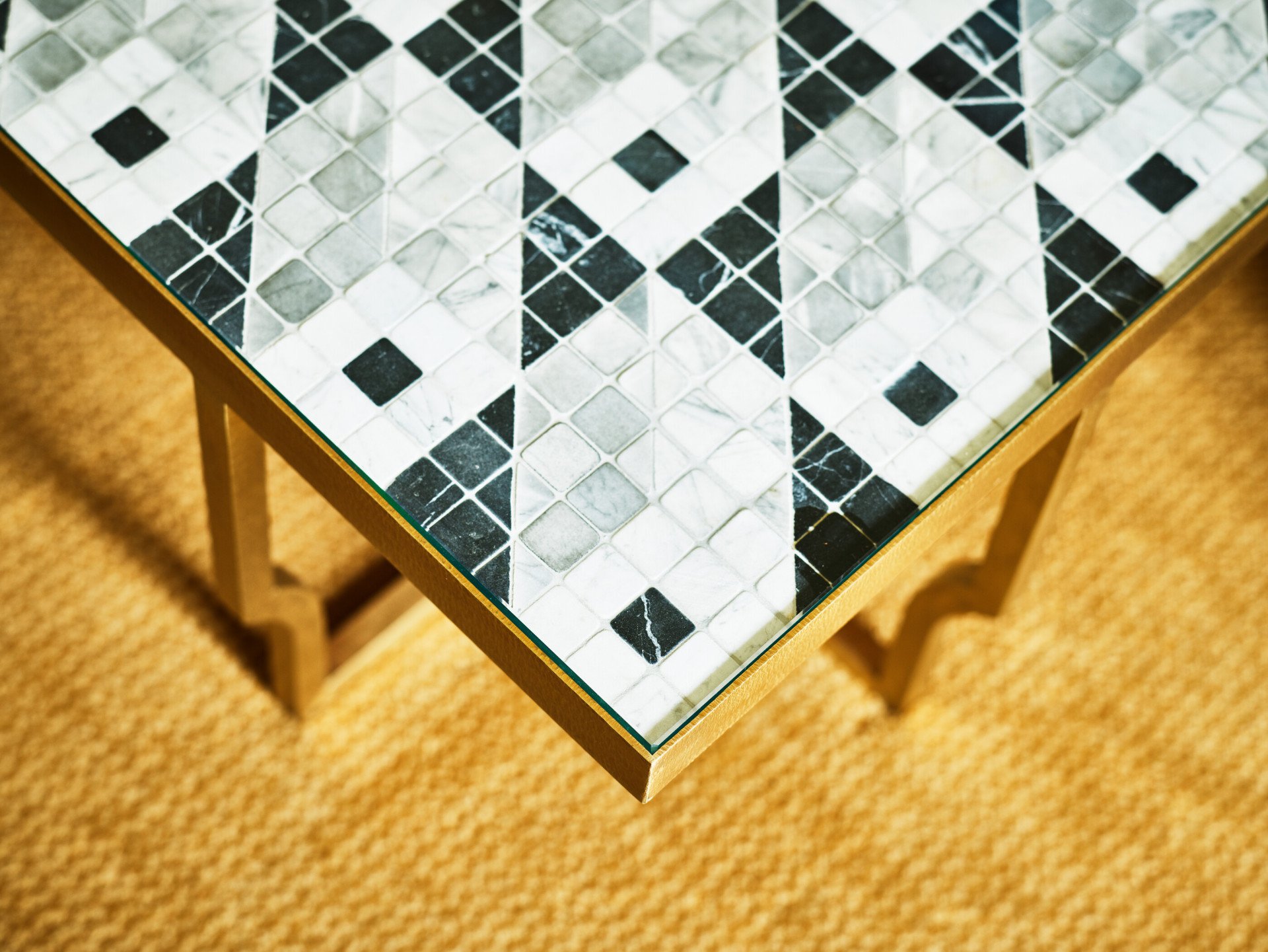 Coffee table with black and white tiles and golden base at Classic Suite at Hotel Eden, Rome