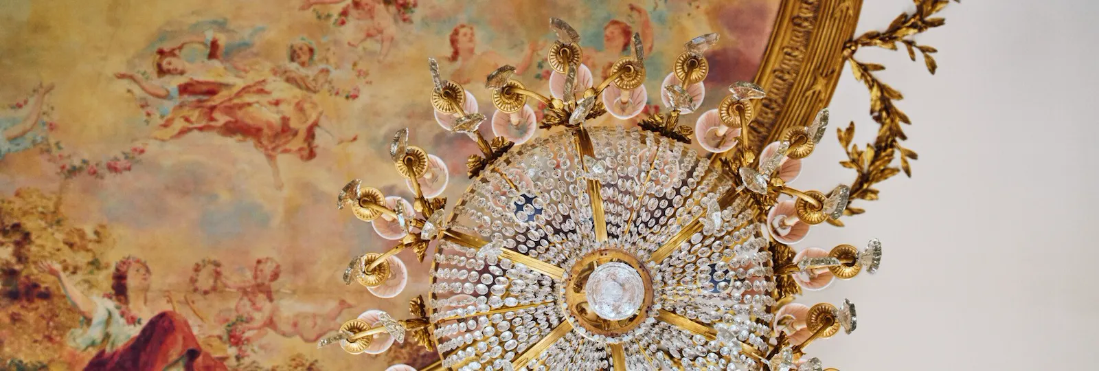 Zoom on a detail on the ceiling of le Restaurant le Meurice Alain Ducasse, a painting behind a chandelier, at Le Meurice, Paris