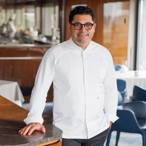 Portrait of executive chef Salvatore Bianco standing inside restaurant La Terrazza at Hotel Eden Roma