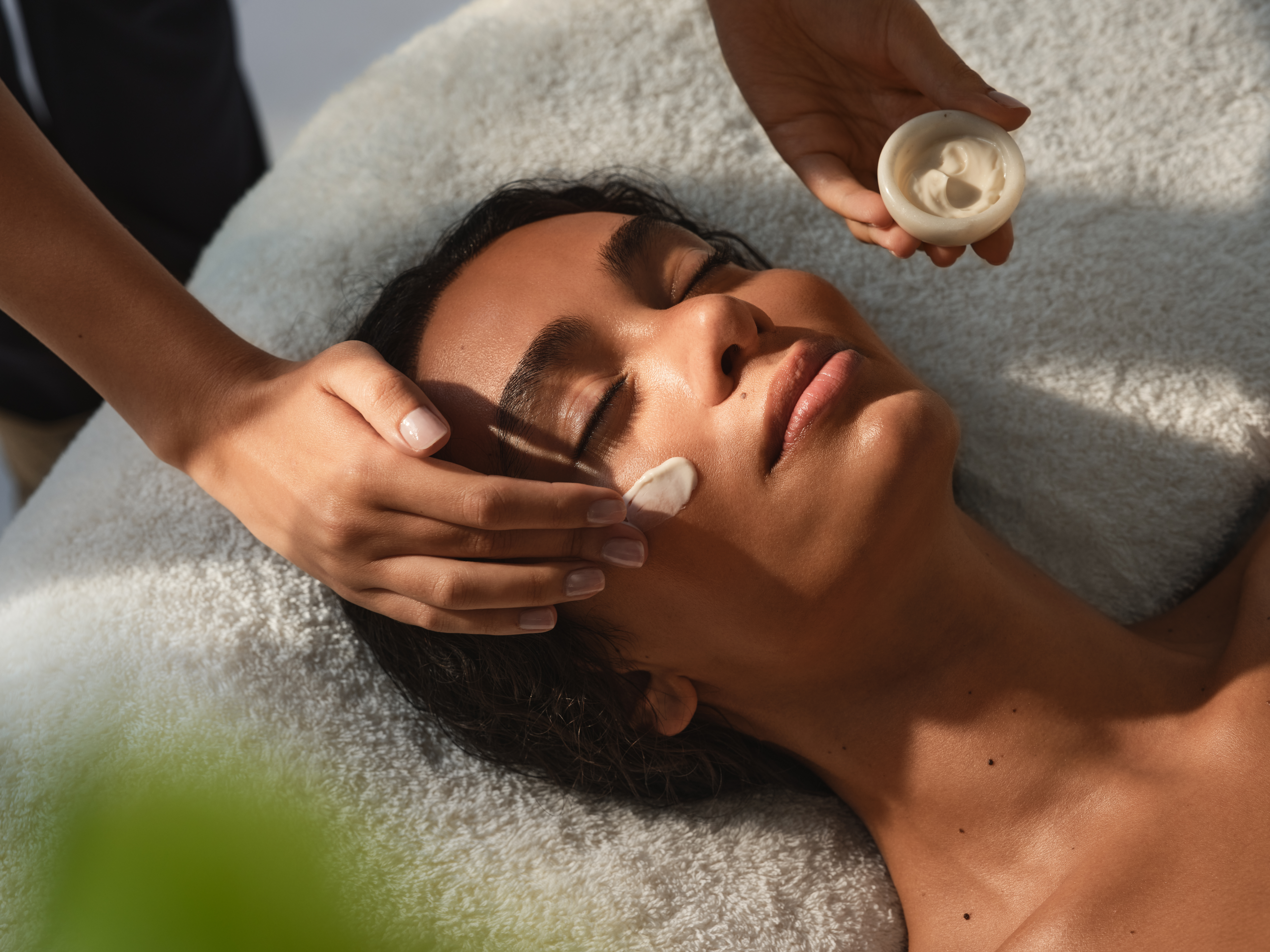 The Dorchester Spa Treatment Facial Cream being applied to woman's face