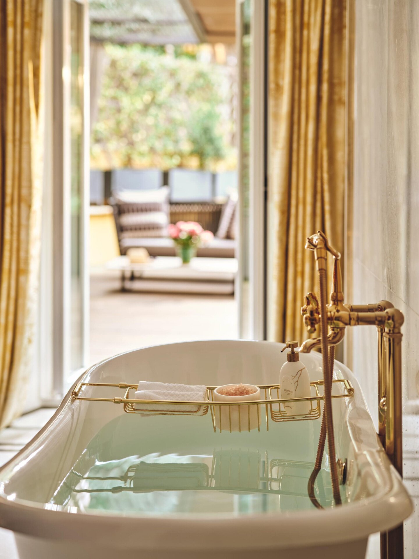 Bathtub filled with water in Aurora Terrace Suite at Hotel Eden rome