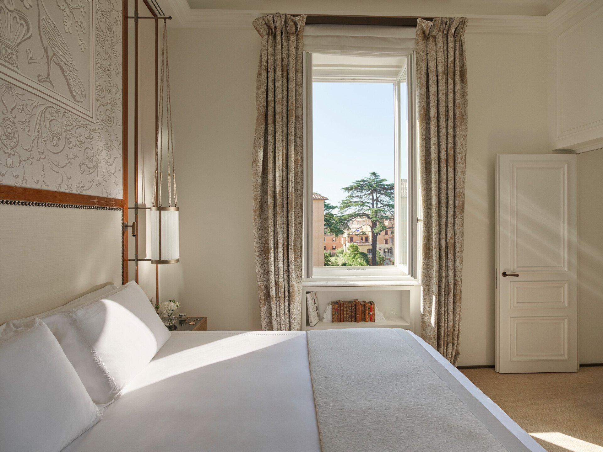 Elegant bedroom of Prestige Suite with view of Rome at Hotel Eden