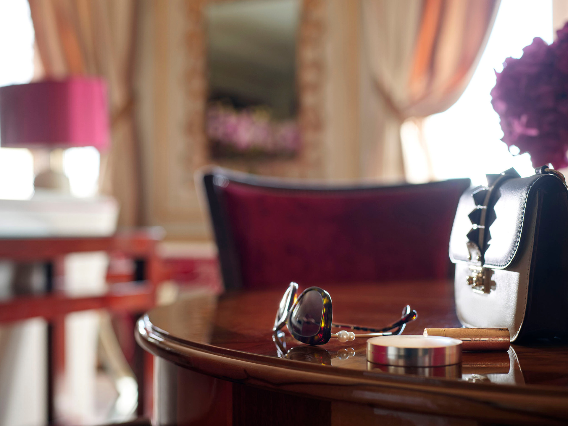 Imperial Executive Suite Detail with sunglasses, make up essentials and a pale brown handbag