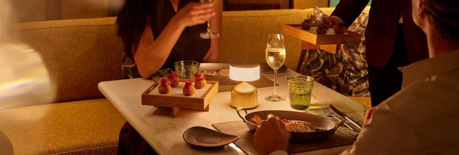 A couple enjoying drinks at Jara by Martin Berasategui