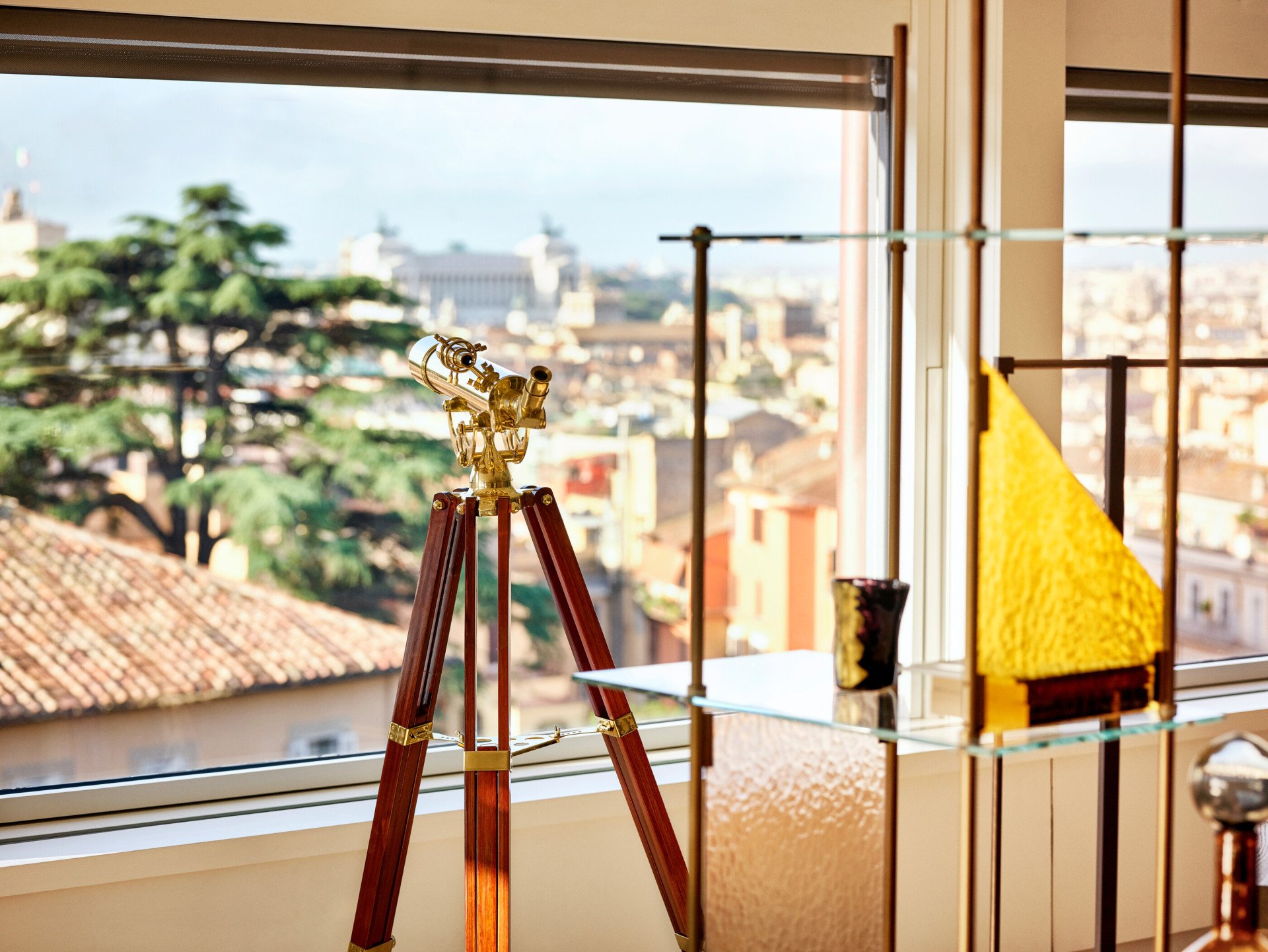 Telescope in front of open window in Bella Vista Penthouse suite at Hotel Eden, Rome