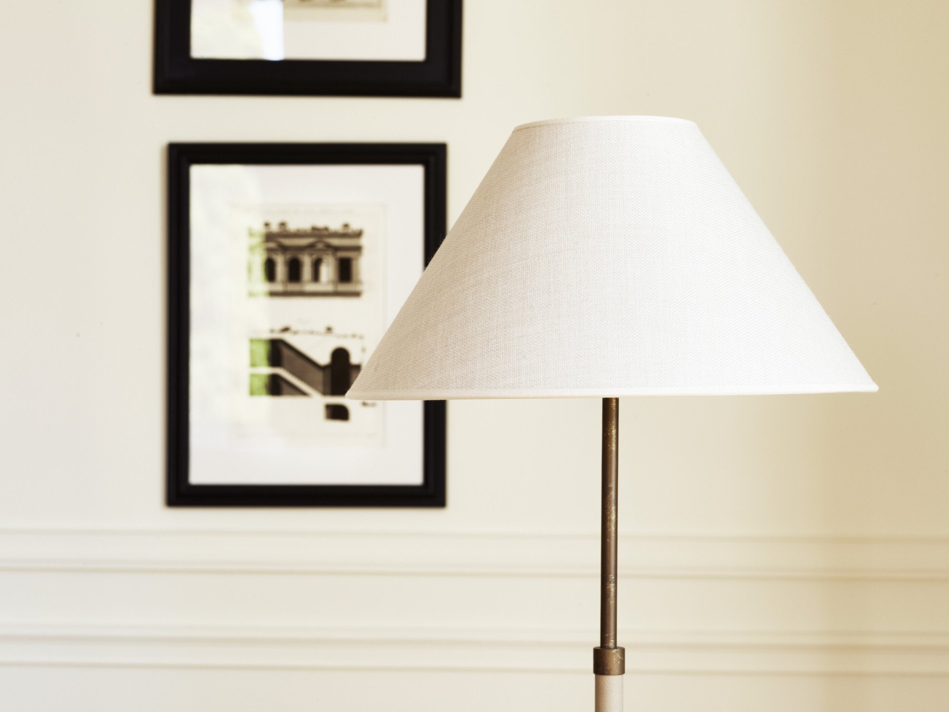 Lamp with white lampshade and paintings in the background at Dolce Vita Suite at Hotel Eden, Rome