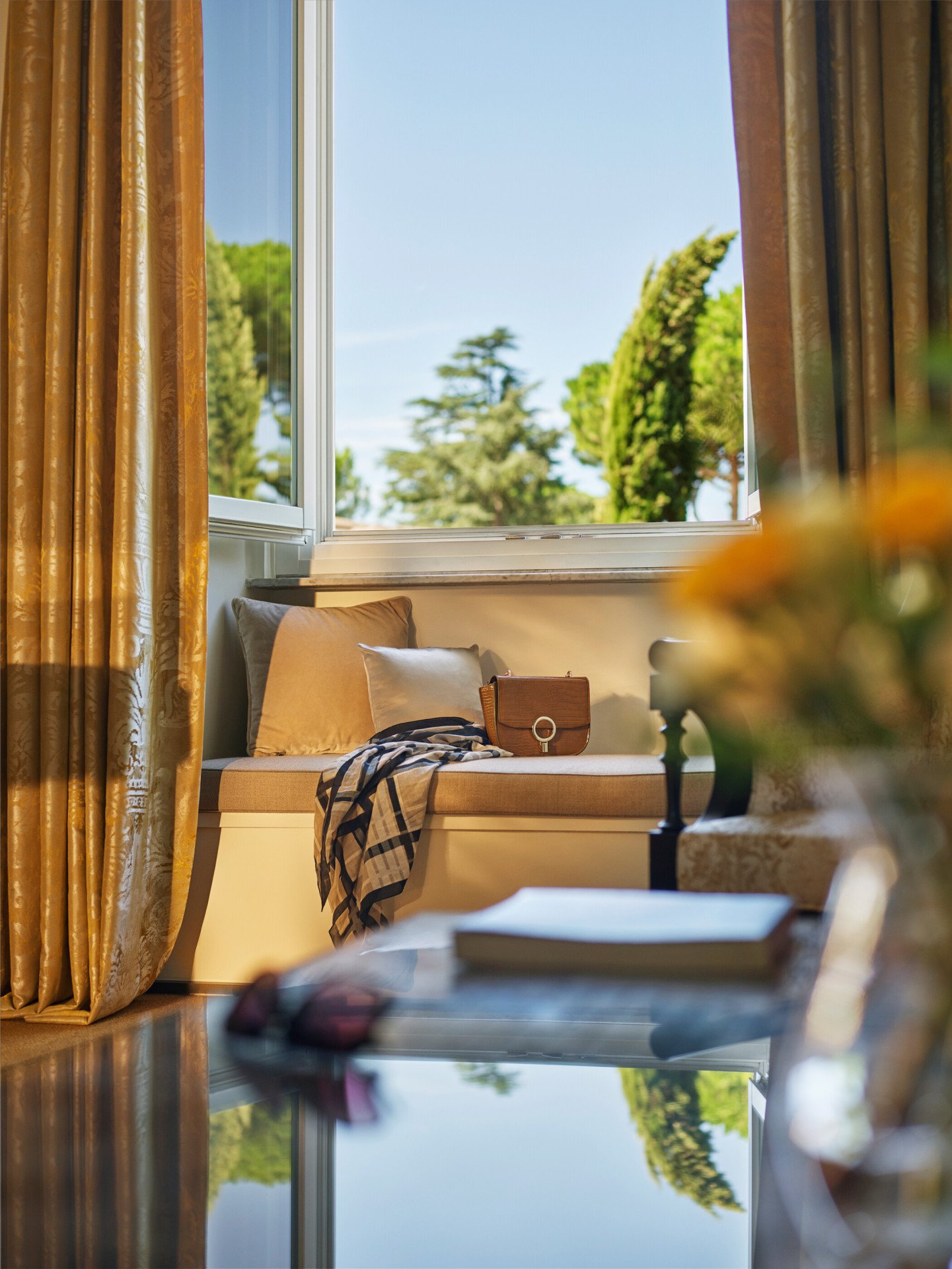 Classic room living room detail with open window and bag on couch at Hotel Eden, Rome