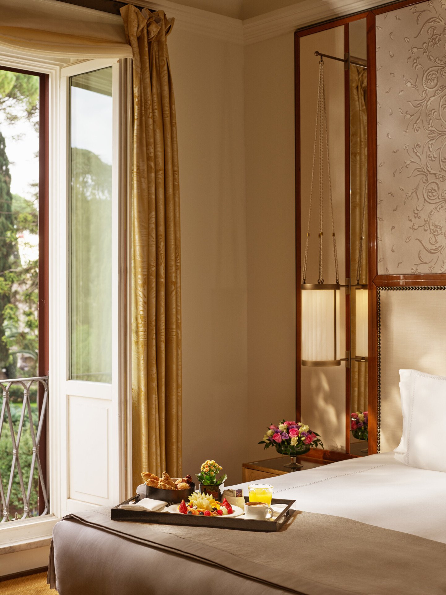 Bedroom of classic room with view, breakfast tray on the bed, at Hotel Eden 