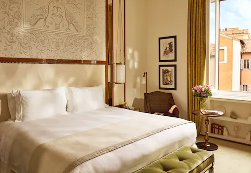 Bedroom of prestige room, headboard with peacocks illustration and window with view, at Hotel Eden, Rome