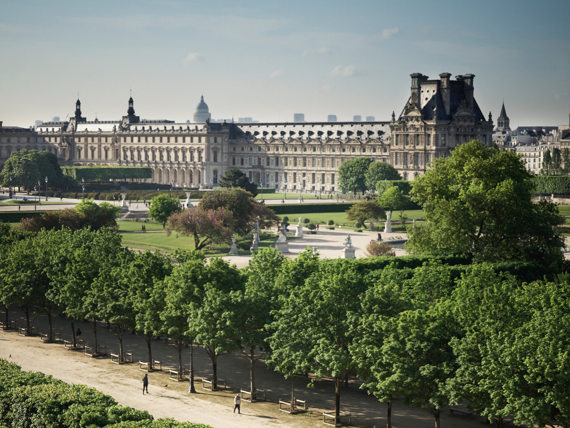 View of the Tuileries Garden from a distance, with daylight and an alley of trees. At Le Meurice, Paris.
