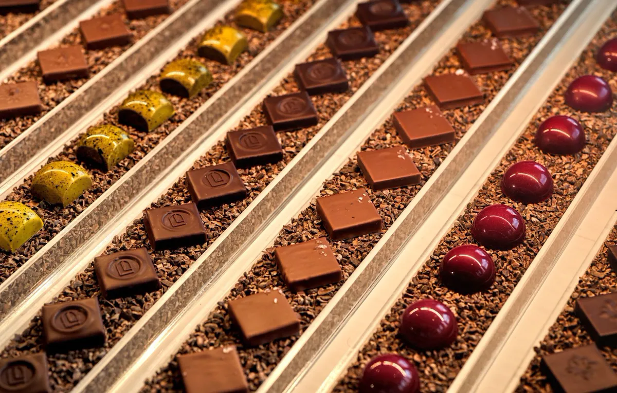 Pictures depict Bonbon Café Angelo Musa offerings, including chocolates and pastries.