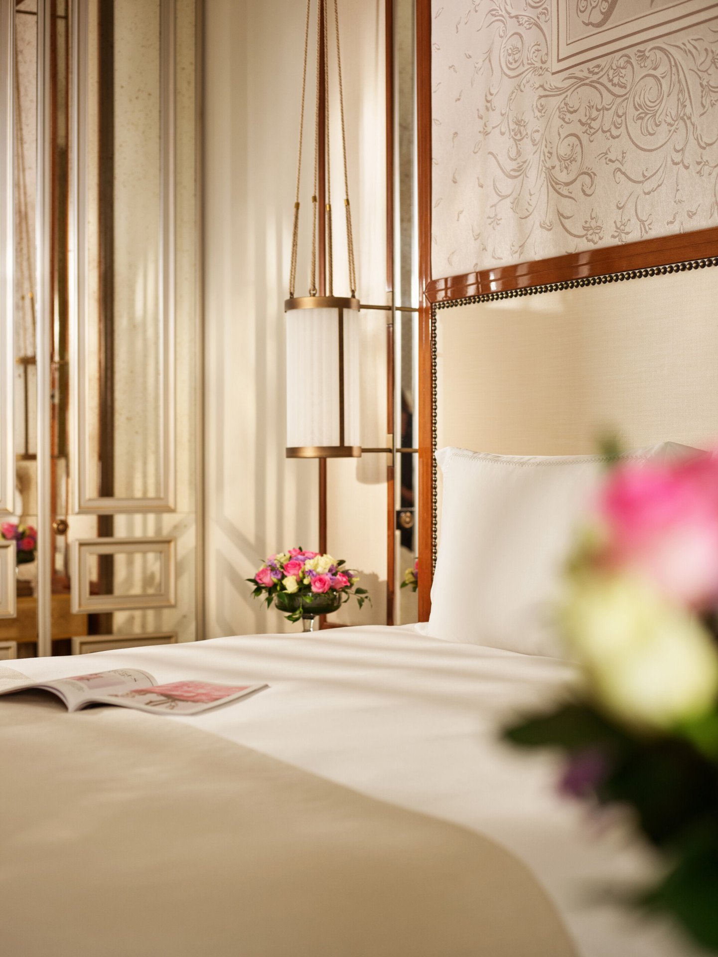 Close up on bedroom of prestige room, headboard with peacocks, night tables with flowers, at Hotel Eden, Rome