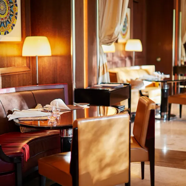 Table at CUT restaurant set for lunch with sun streaming in, at 45 Park Lane, London