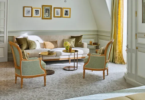 Living room of a deluxe junior suite with green and yellow undertones, at Le Meurice, Paris.