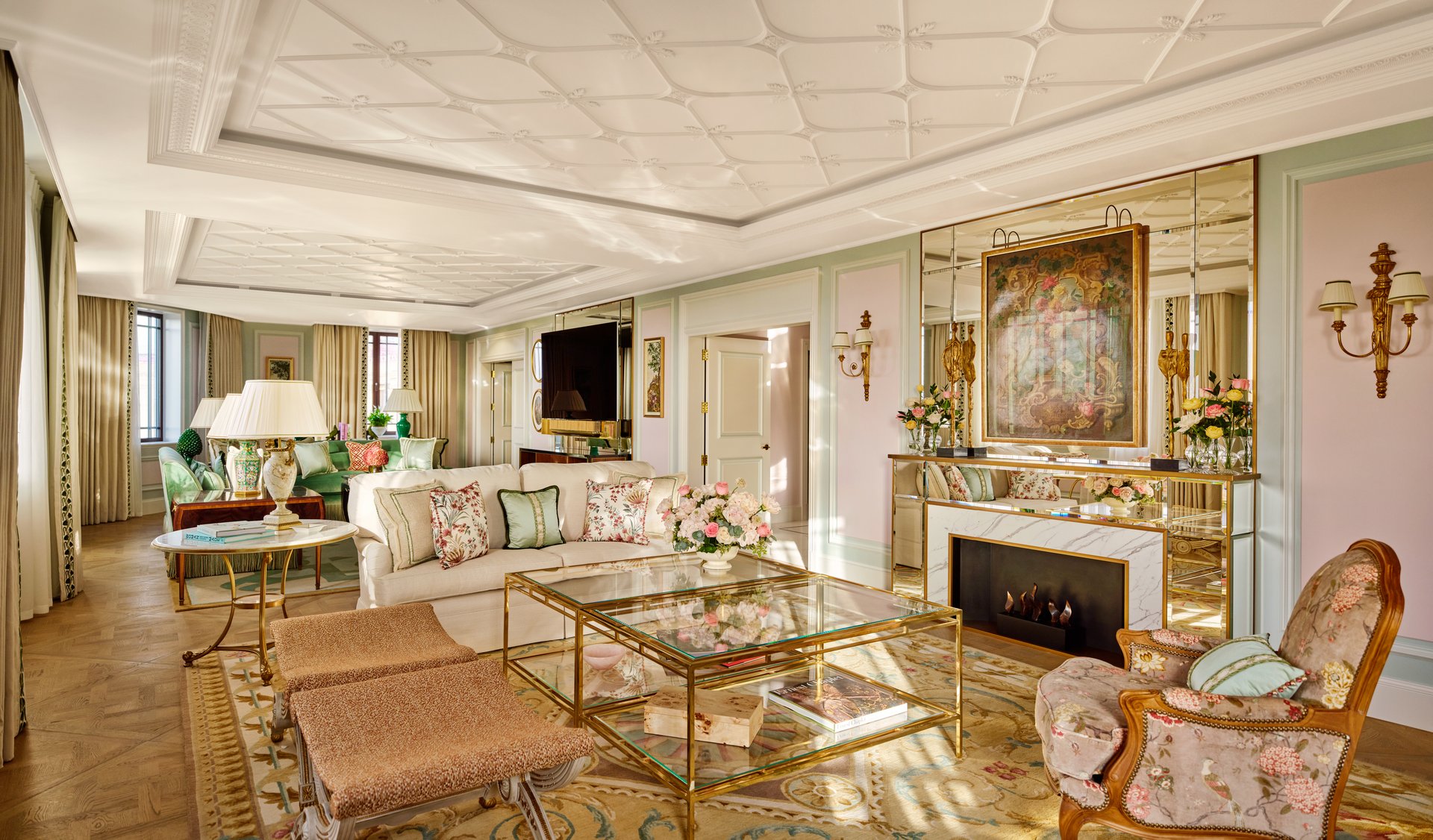 Elegant living room with vintage furniture, fireplace, floral decor, and a cozy atmosphere