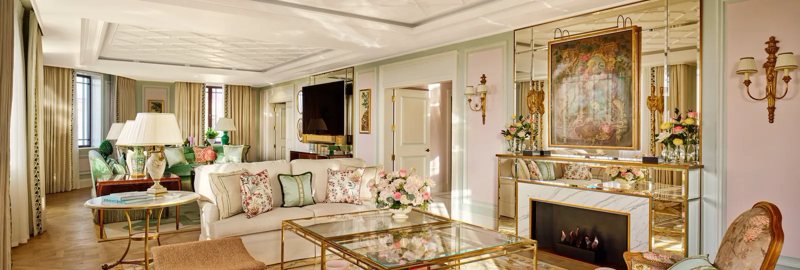 Elegant living room with vintage furniture, fireplace, floral decor, and a cozy atmosphere