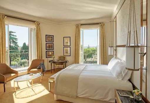 Junior Suite bedroom with windows open to view at Hotel Eden, Rome