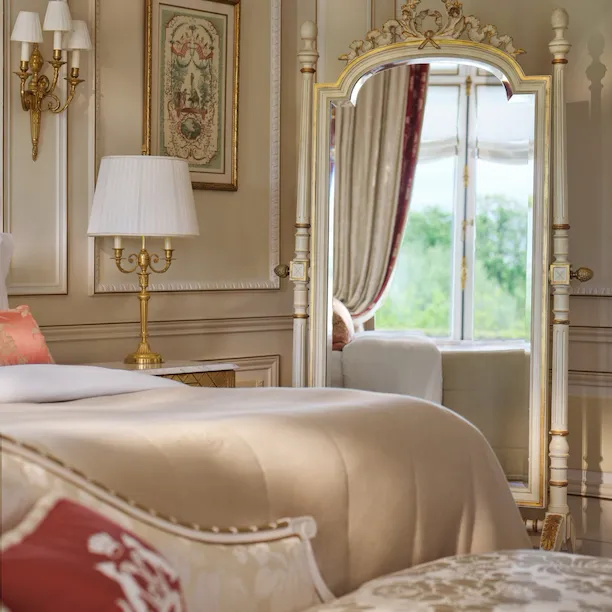Reflect of the bed and the curtain in the mirror of a Versailles Suite, at Le Meurice, Paris