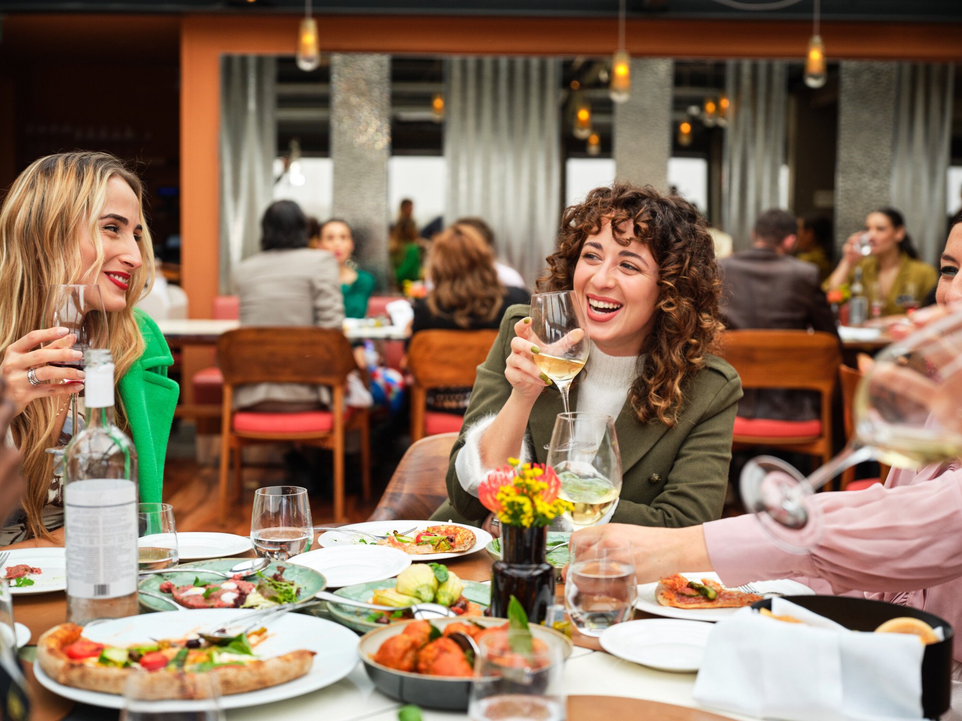 Portrait of smiling ladies having lunch at Il Giardino Ristorante, Hotel Eden 