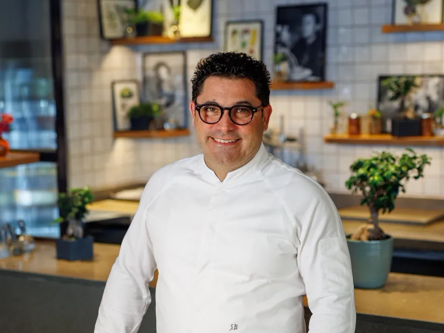 Portrait of executive chef Salvatore Bianco standing at the sharing table at Il Giaridno Ristorante