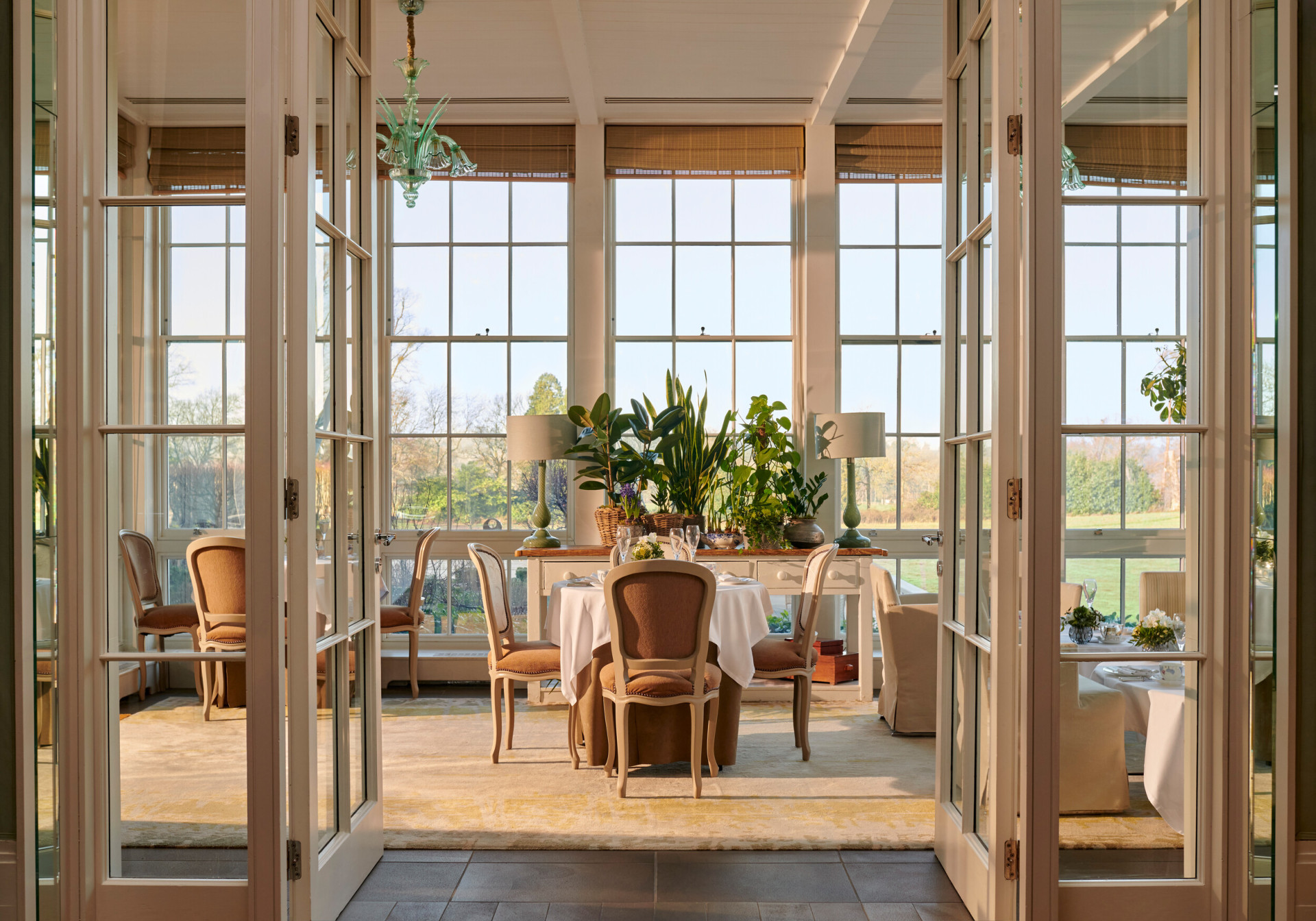 Open glass doors leading to a set up table in the central portion of the image.