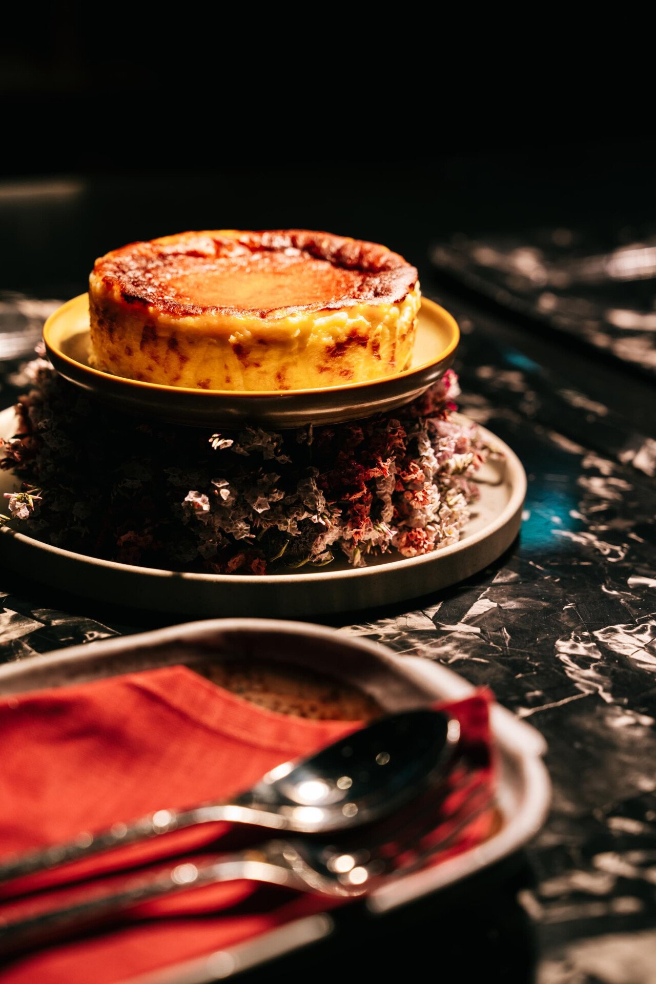 Images depicting interiors as well as food and beverage offerings at Jara by Martín Berasategui located at The Lana, Dorchester Collection, Dubai, including fish display and new cocktails, such as La Luna, captured on a red table top.