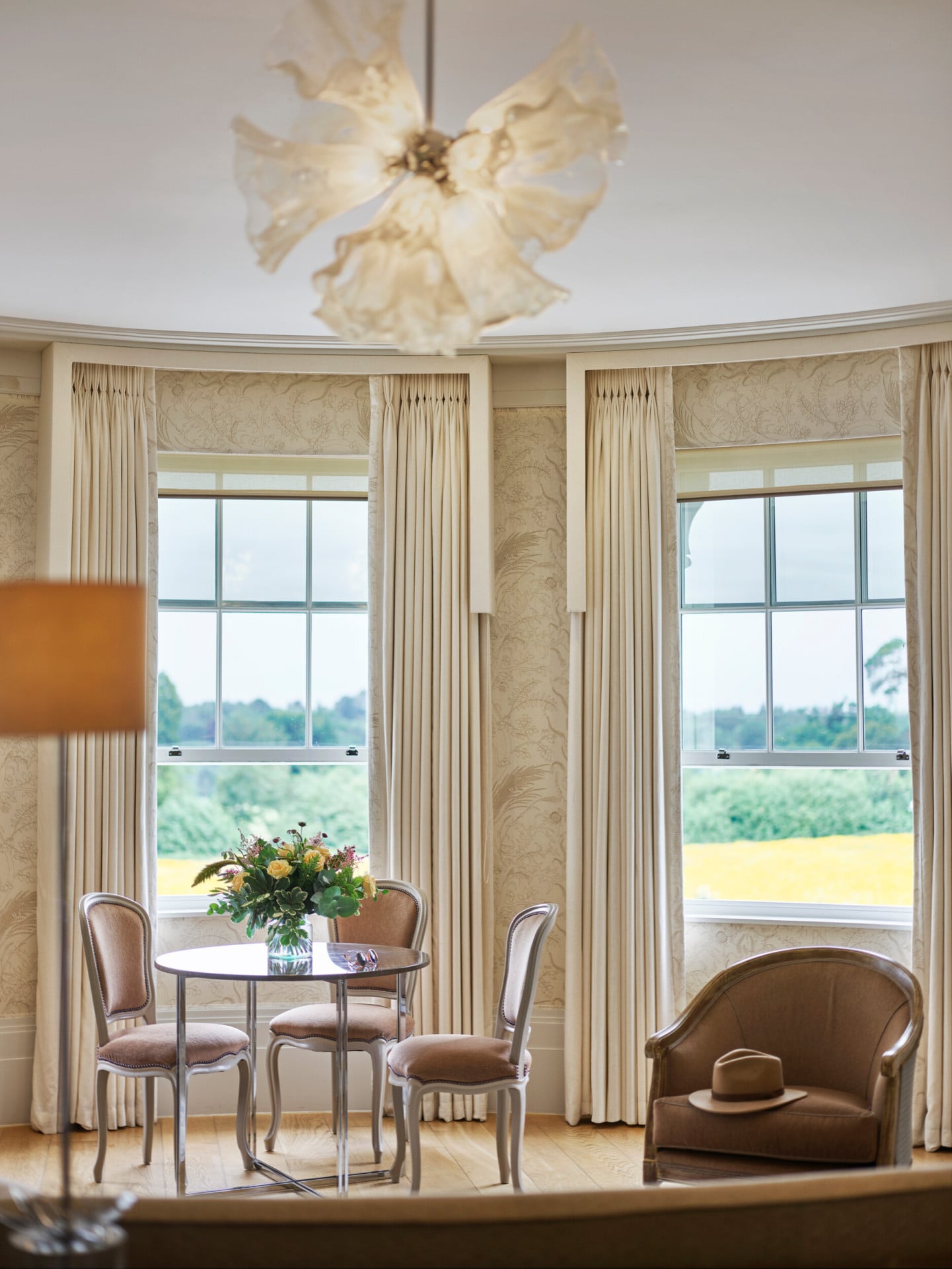 Coworth Park-Mansion House Premium Suite view of the dining table and out of the window towards the meadow