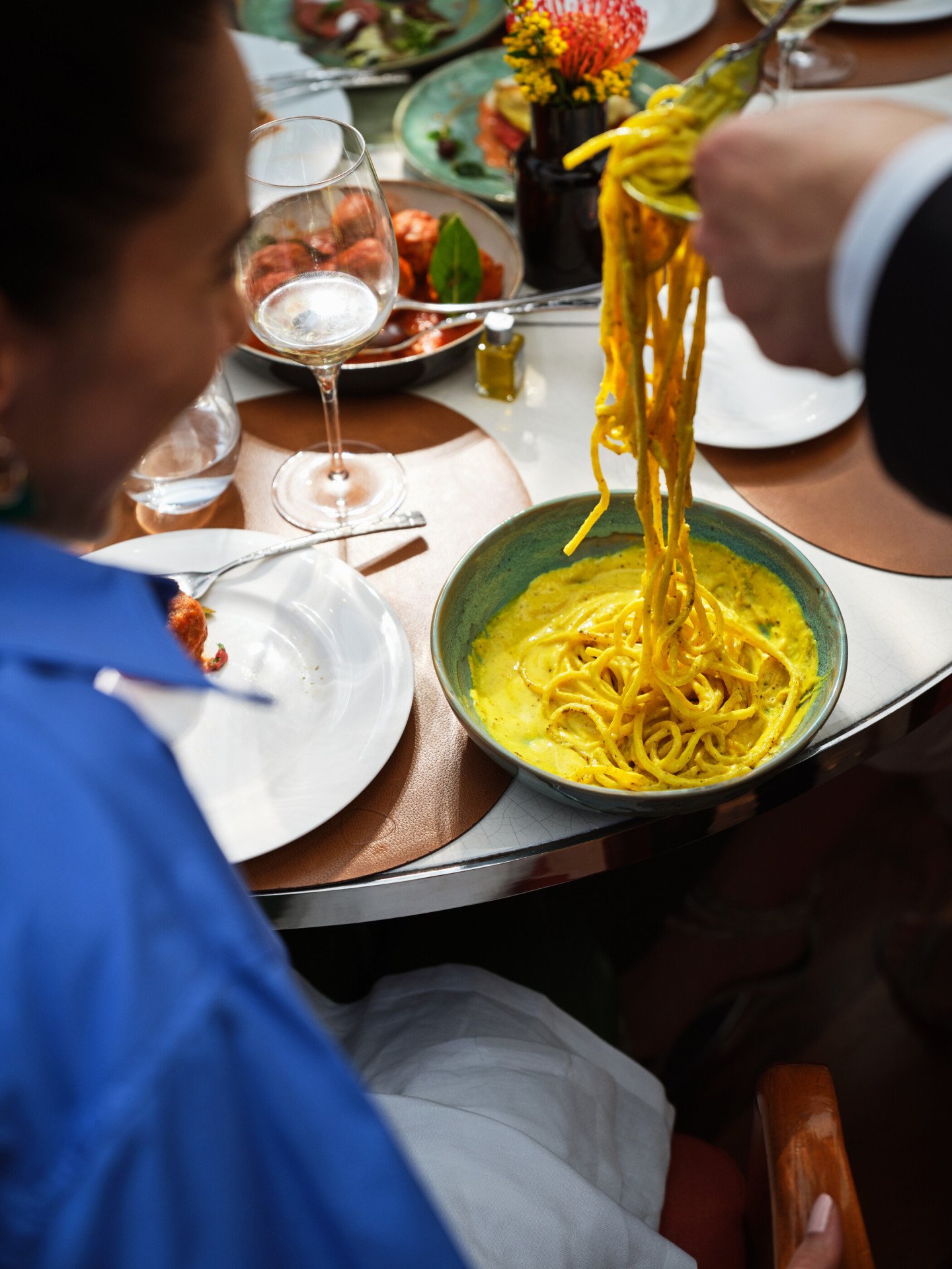 Close up of waiter serving spaghetti at Il Giardino Ristorante, Hotel Eden