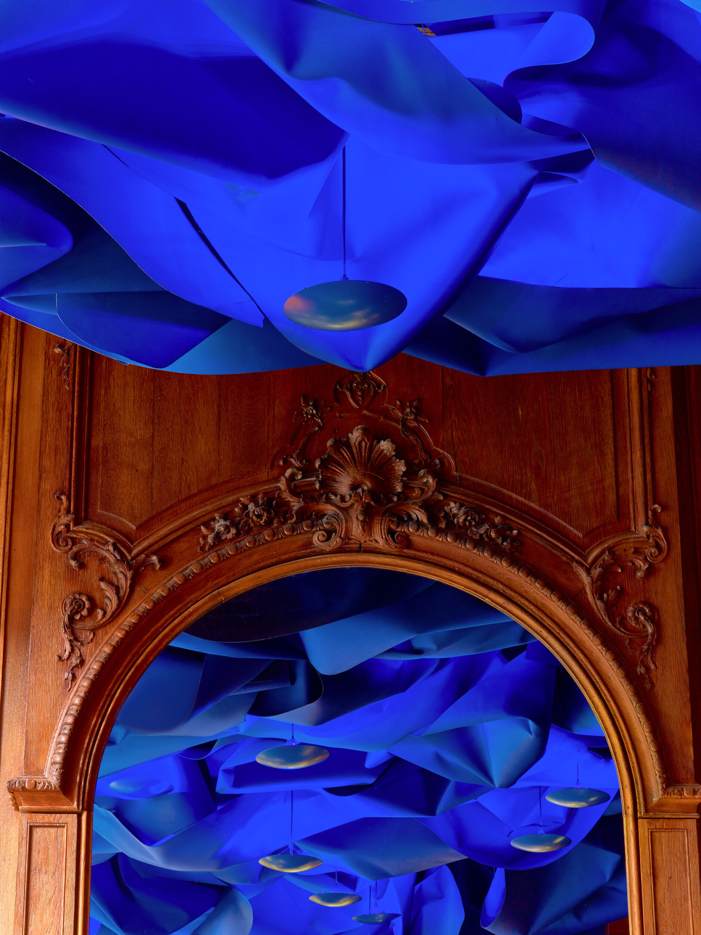 Le Bar's Draped fabric ceiling inspired by haute couture dresses and illuminated by blue lights, at Hotel Plaza Athénée, Paris 