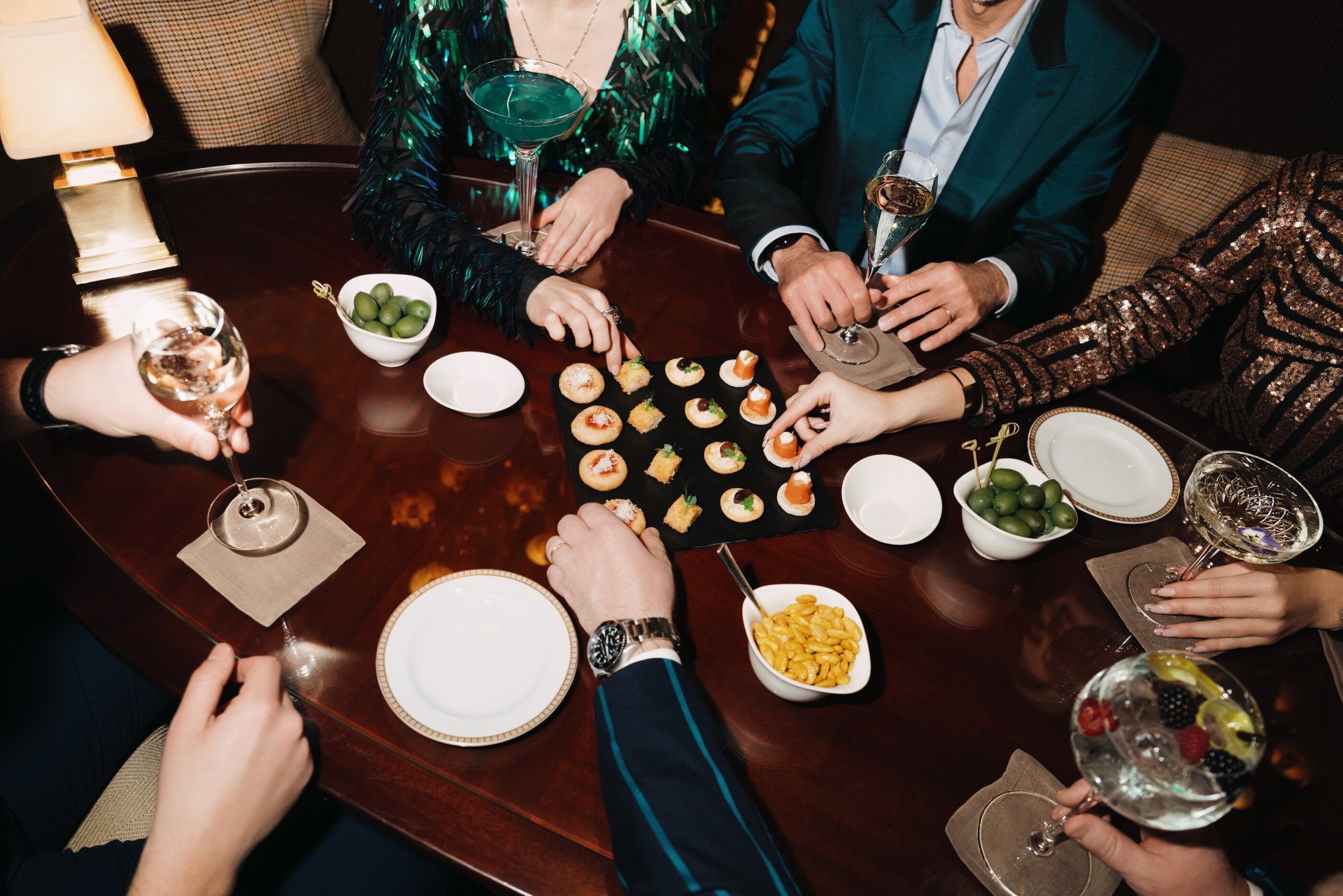 Detail of canapes and cocktails on a brown table at Principe Bar 