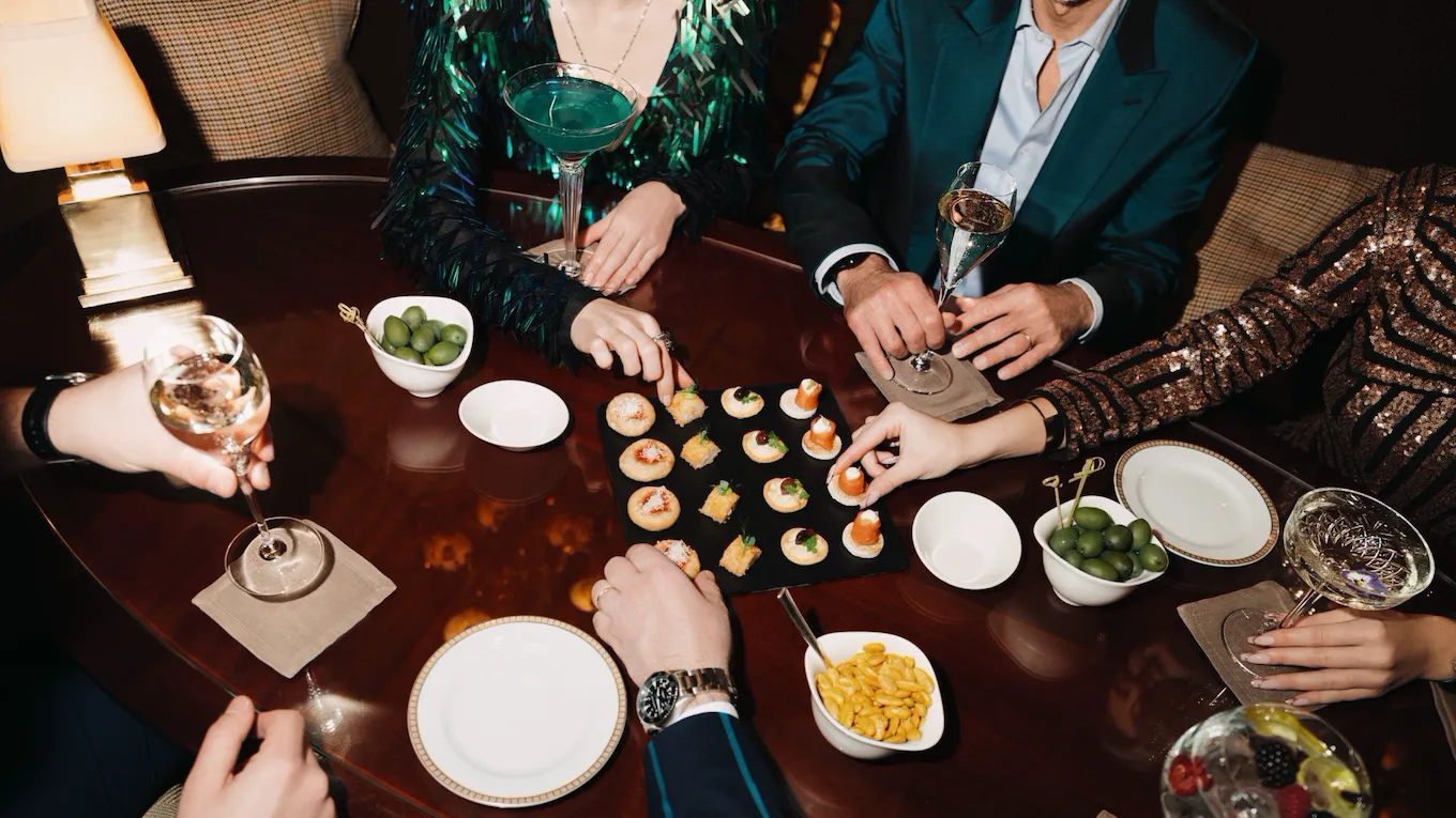 Detail of canapes and cocktails on a brown table at Principe Bar