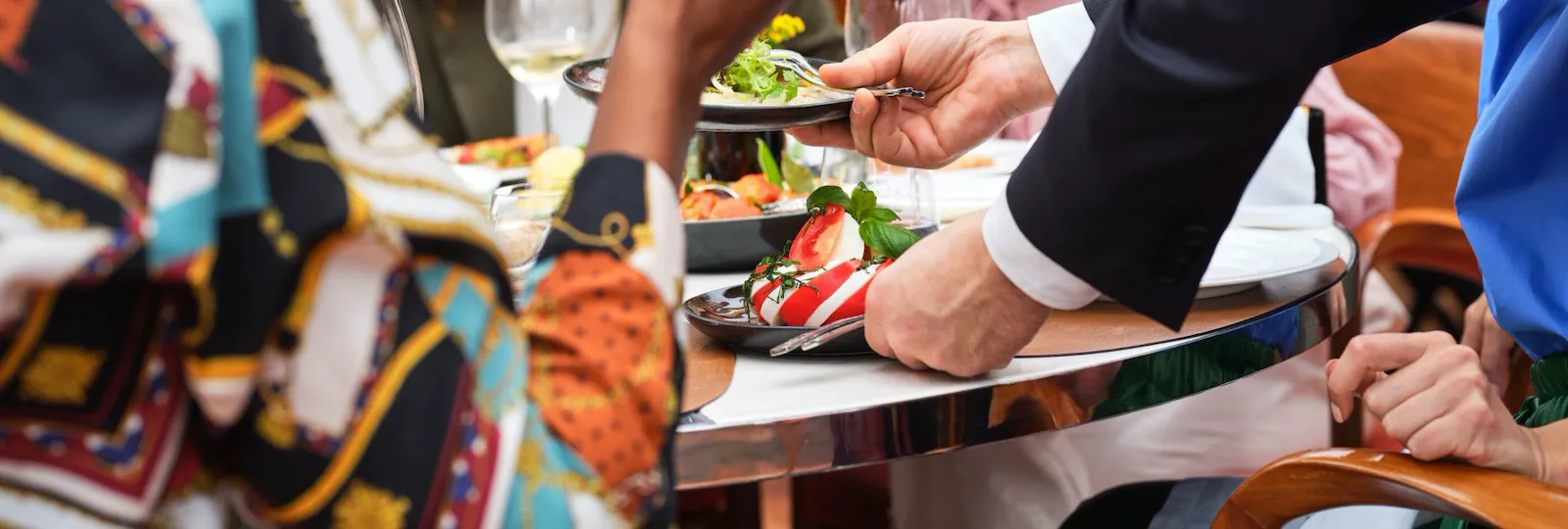 Close up on table composed by friends cheering at Il Giardino Ristorante, Hotel Eden