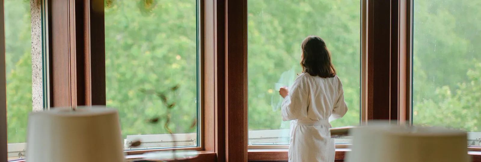 Woman looking out window of Park Lane Studio