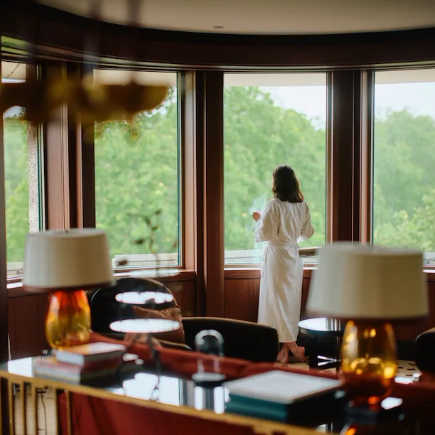 Woman looking out window of Park Lane Studio