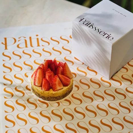 Seasonal cheesecake on top of Patisserie branded tissue paper and Patisserie branded box