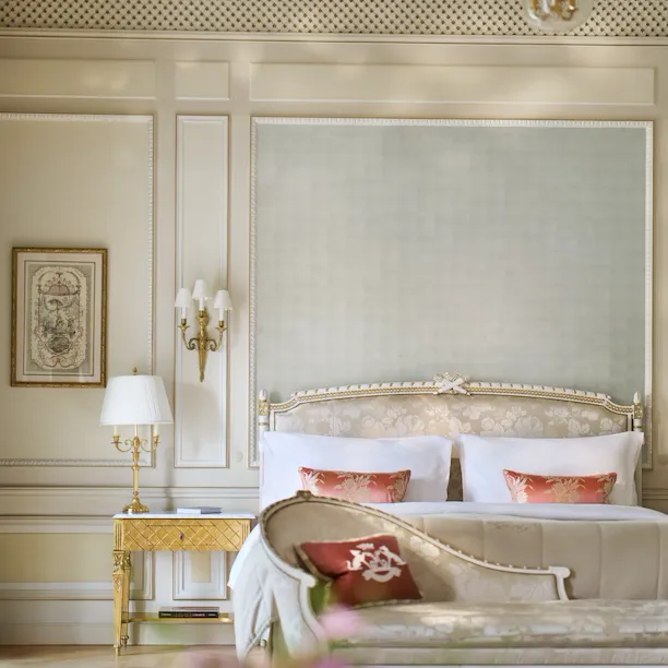 Front view of the bedroom of a Versailles Suite with the bed behind the couch, at Le Meurice, Paris