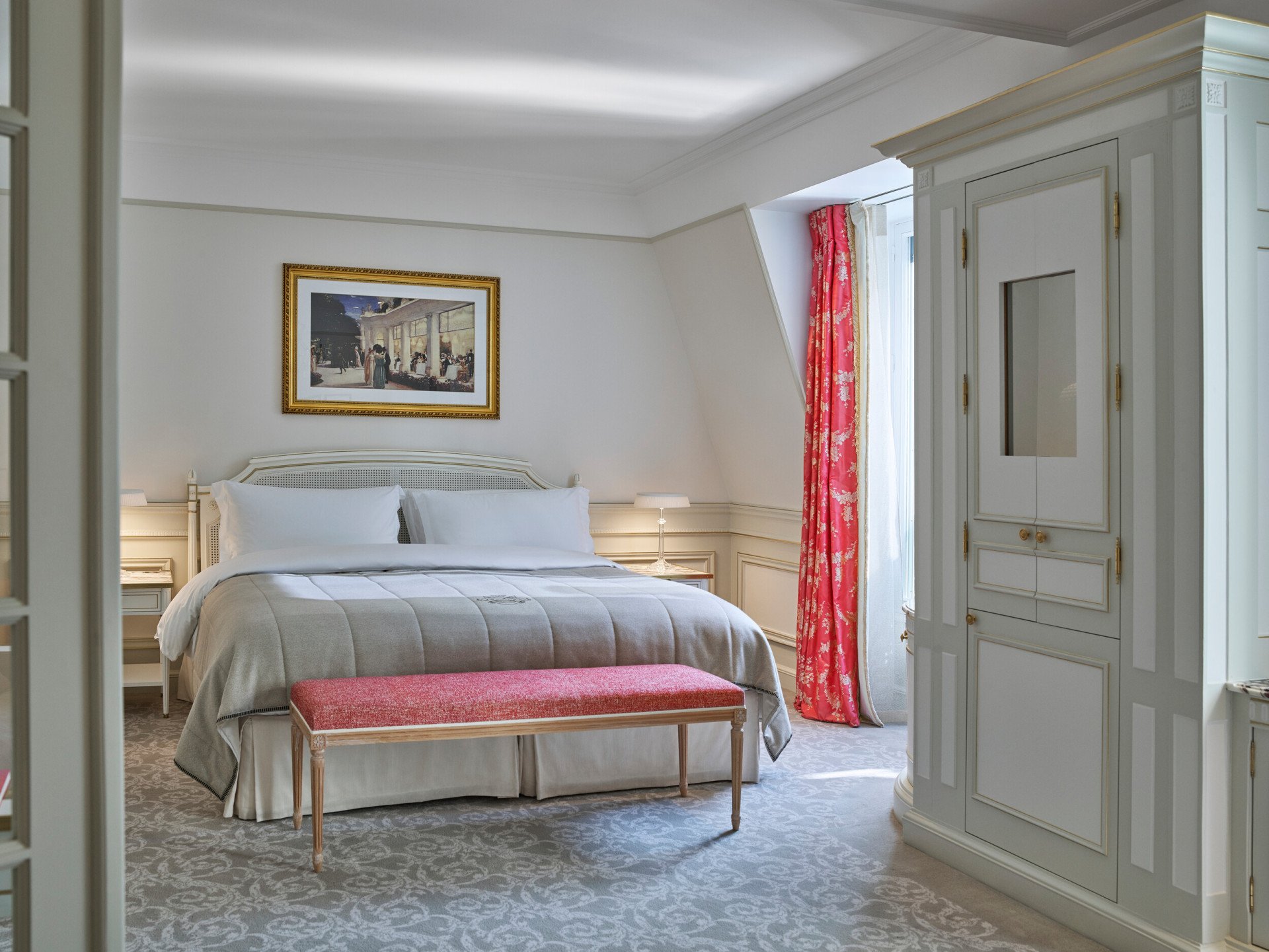 Bedroom of an executive junior suite with pink curtains at Le Meurice, Paris.