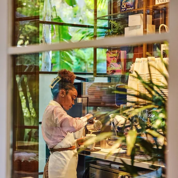 Barista pouring coffee in The Patisserie