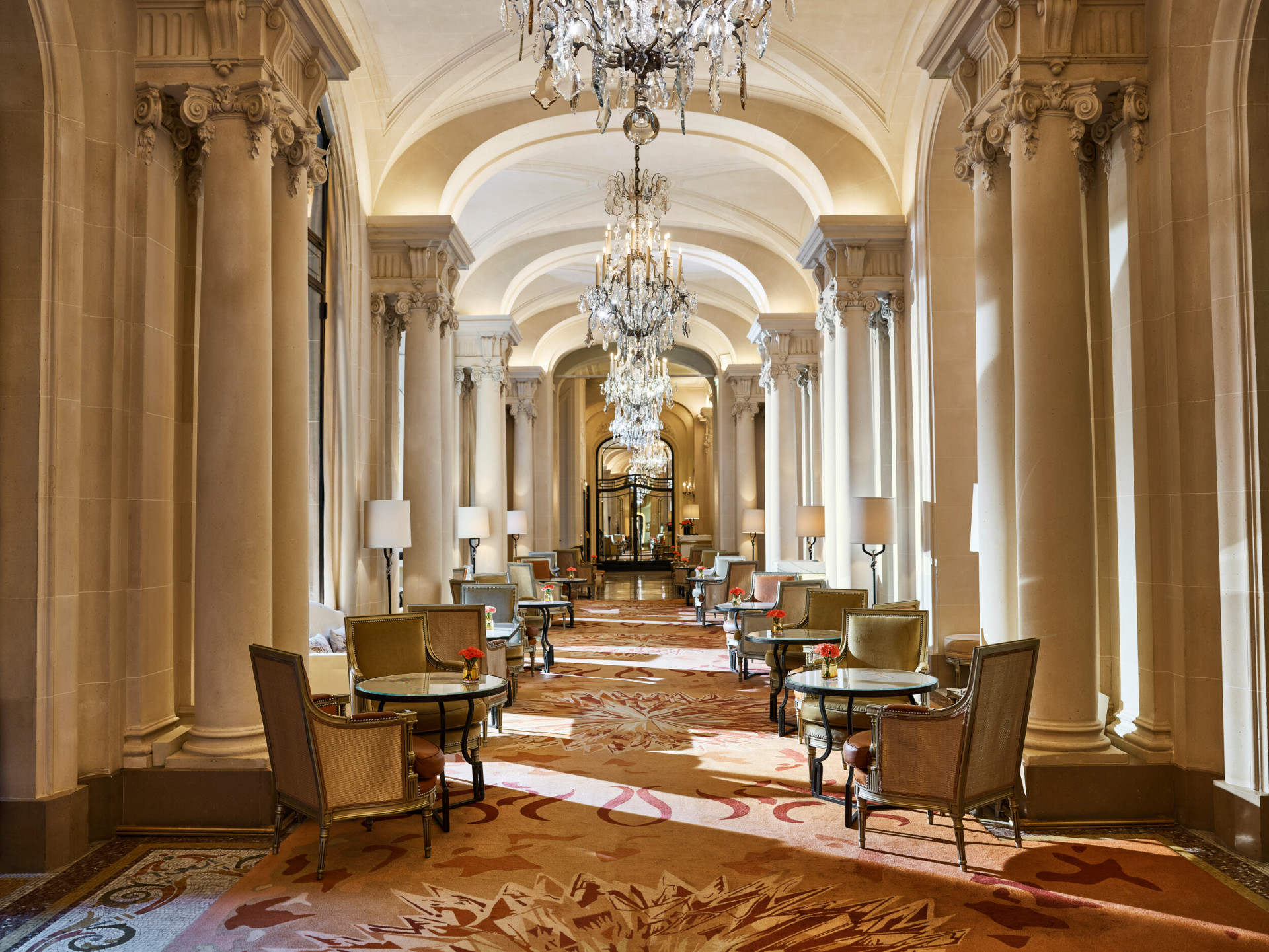 La Galerie dining room corridor with its chandeliers and set up tables, at Hotel Plaza Athénée, Paris