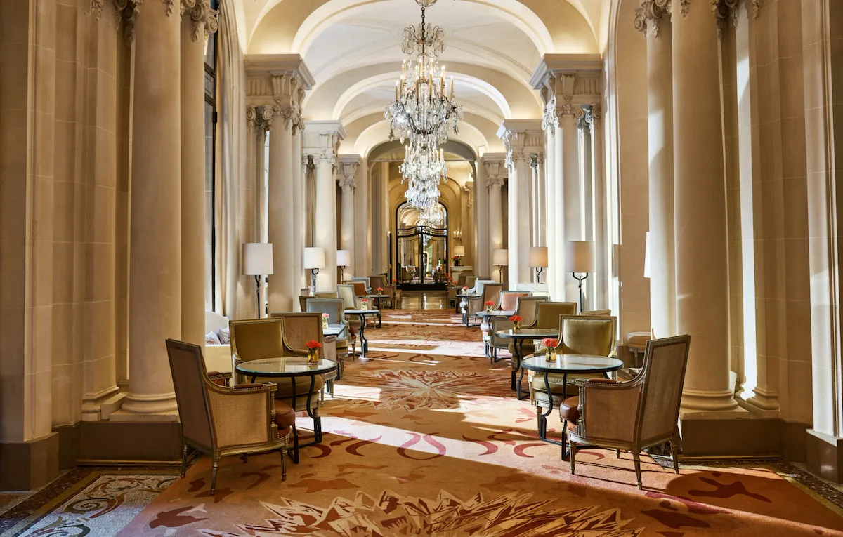 La Galerie dining room corridor with its chandeliers and set up tables, at Hotel Plaza Athénée, Paris